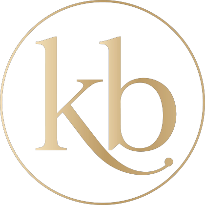 Gold “kb” monogram inside a thin gold circle on a white background