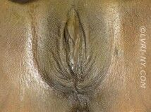 Close-up of human genitalia, with visible labia and clitoris, in shades of brown and tan.