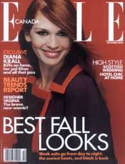 Elle Canada magazine cover, woman smiling, wearing a dark coat with red trim. Headline: 