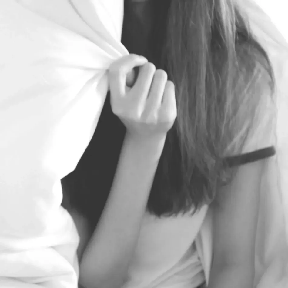 Teenage girl partially hiding behind a blanket, reflecting the challenges teen therapy helps adolescents navigate.