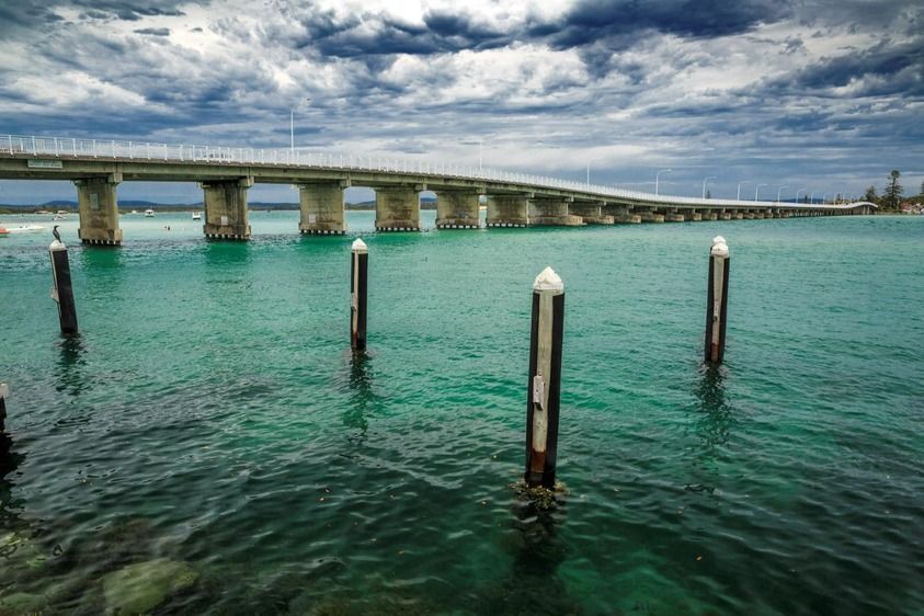 A Bridge Over a Body of Water with A Dock in The Foreground — RiverCity Recyclers In Taree, NSW