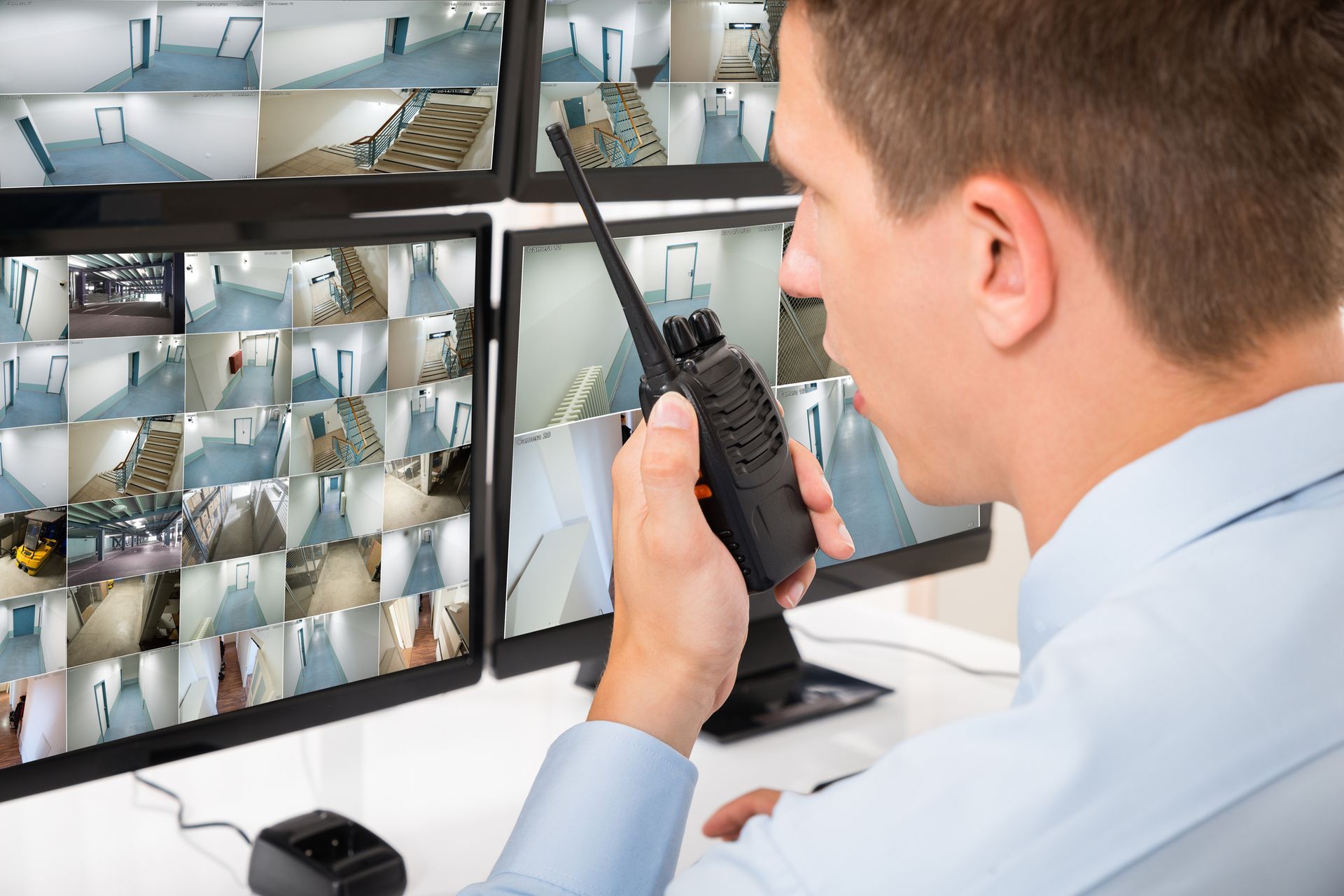 Male Security Guard Talking on Walkie-talkie — Auburn, WA — Five-0 Surveillance