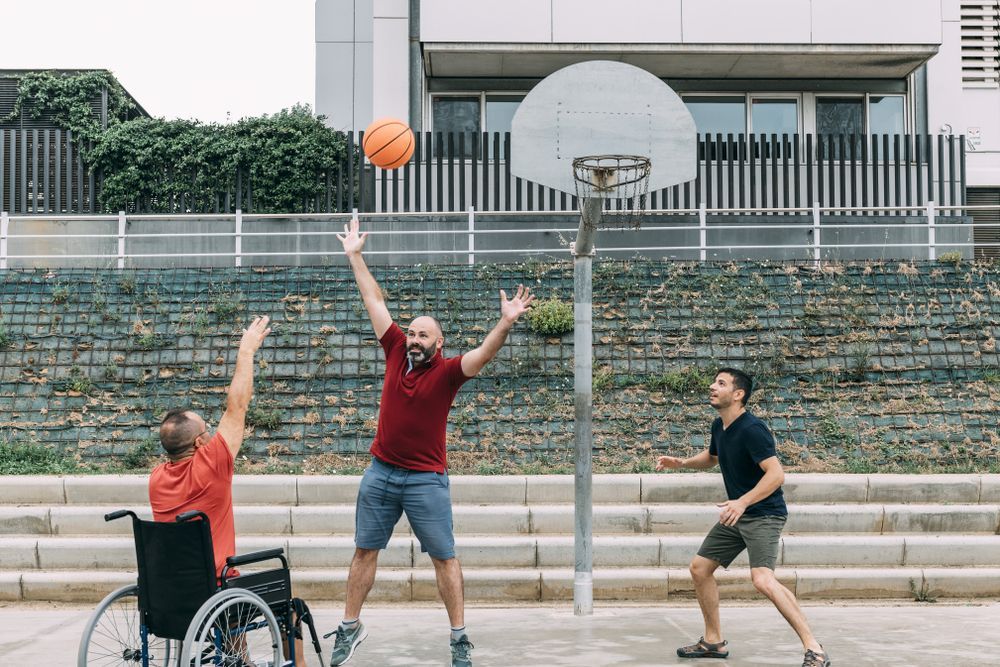 Three People Playing Basketball Outdoors — Home Nursing Services In Laurieton, NSW