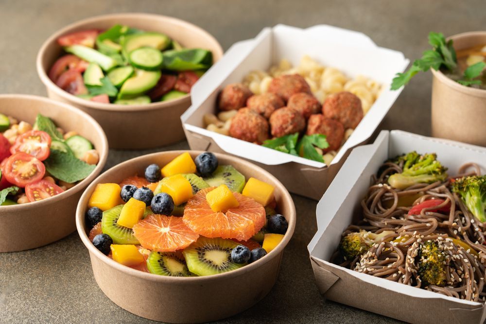 Assorted Dishes in Bowls Fruit Salad, Noodles and Dumplings — Home Nursing Services in Mittagong, NSW