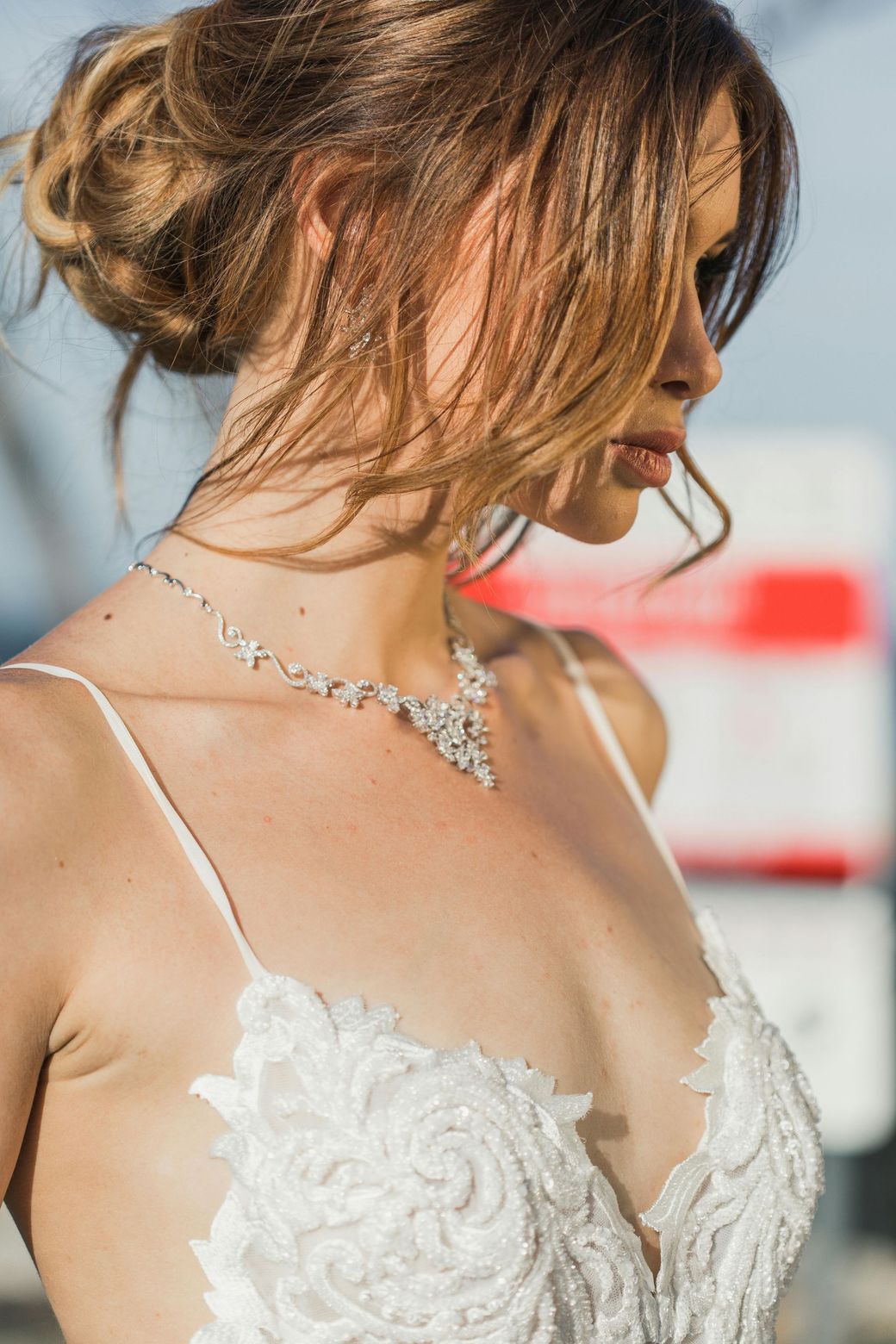 A close up of a bracelet and a belt on a white cloth.