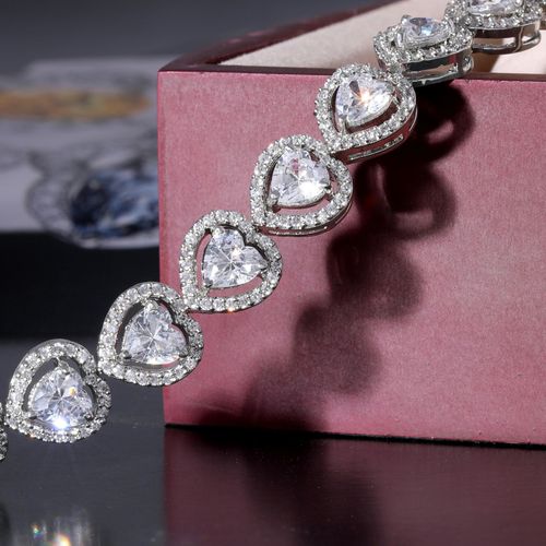 A close up of a ring with a pearl and diamonds