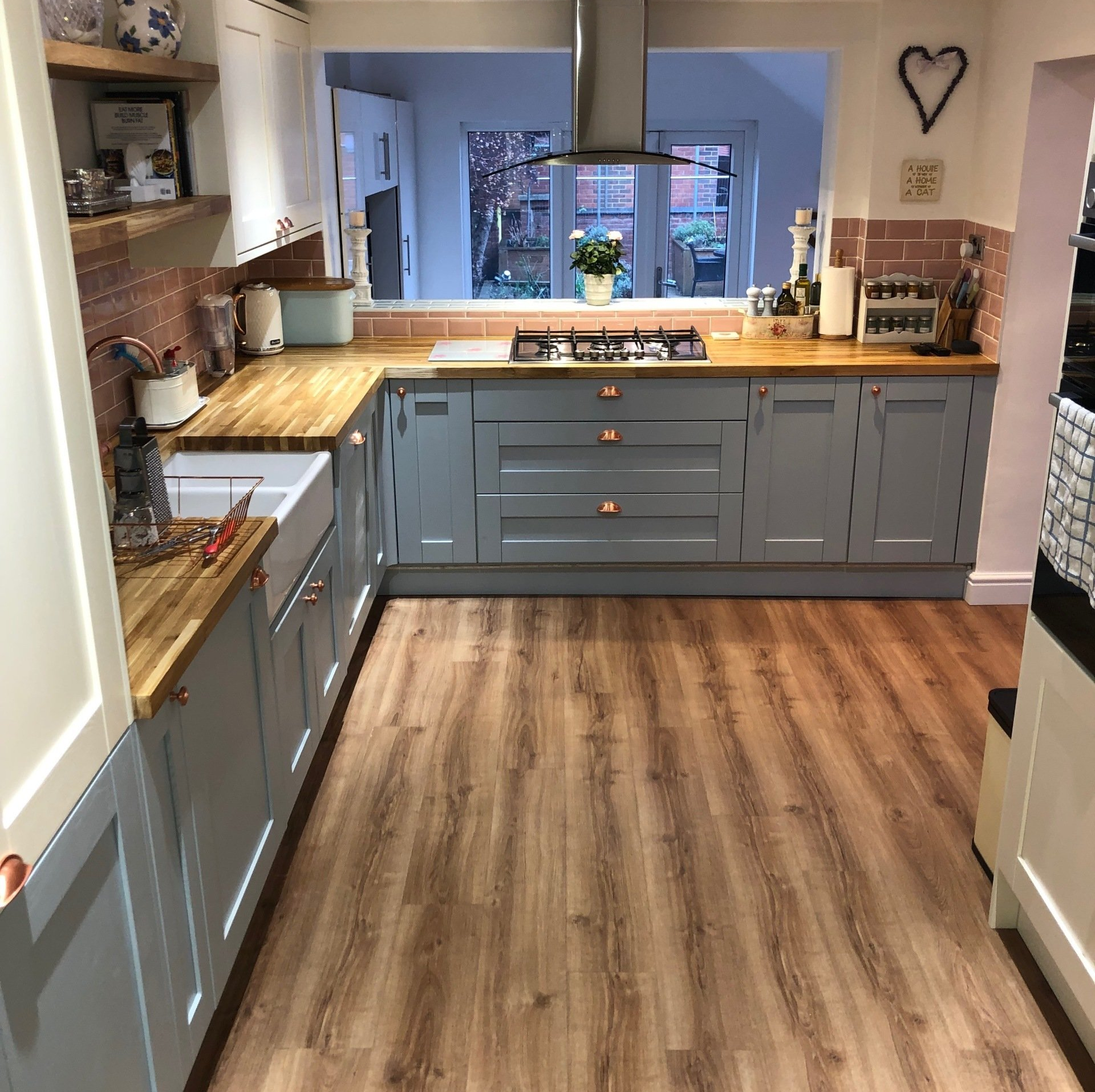 A kitchen with blue cabinets and wooden counter tops