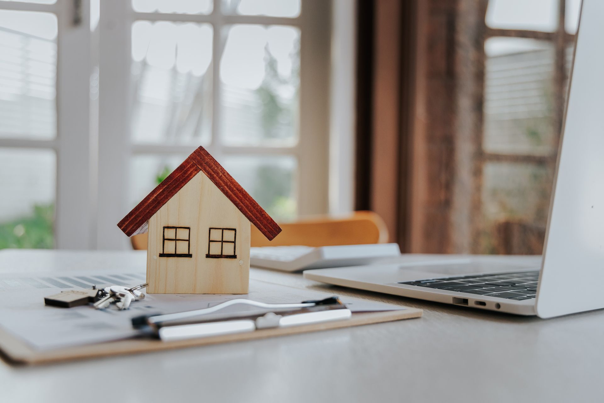 Wooden house model on a desk