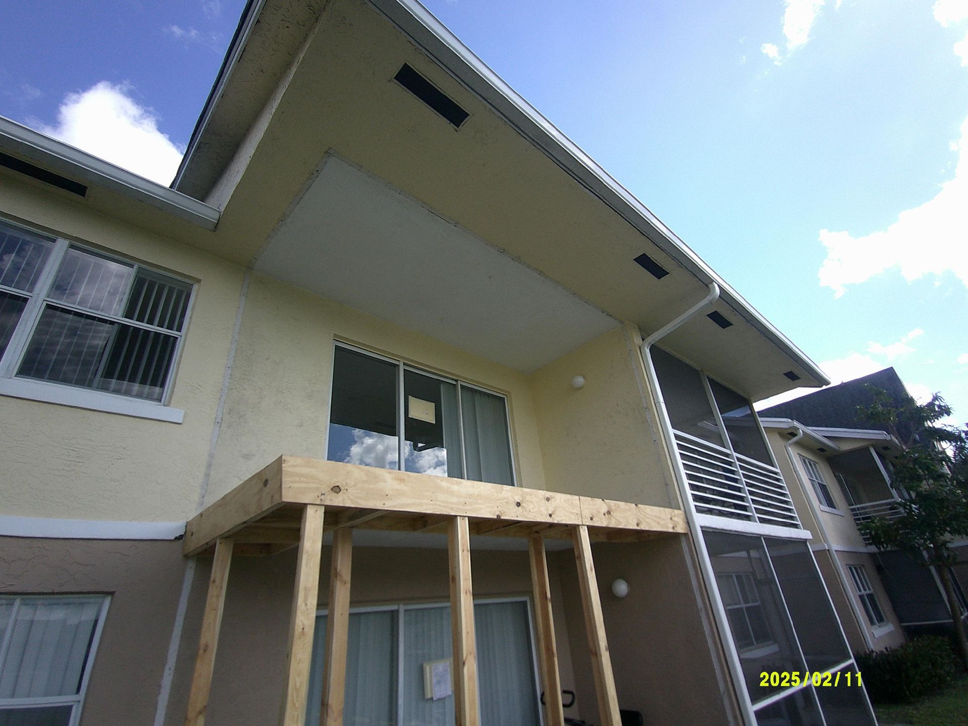 Temporary wood shoring supporting a second-floor balcony during structural repair work in Fort Lauderdale, FL, part of services by M&P Consulting Engineers