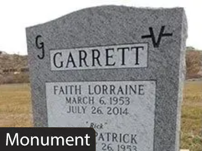 Gray gravestone with GARRETT and names in a cemetery;
