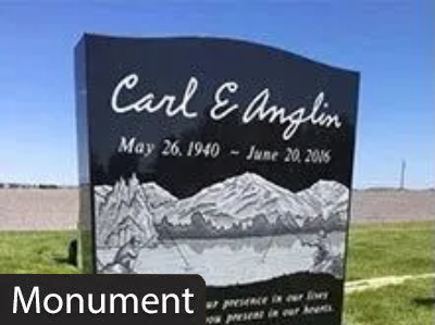 Black granite memorial monument with mountain scene and the name Carl E. Englund.