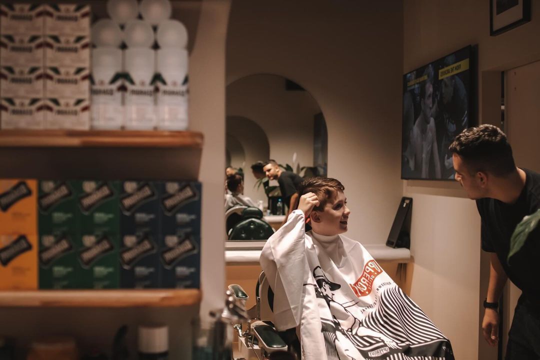 A Barber Checking the Hair of the Young Boy — Barber Bros & Co - Southport in Southport, QLD