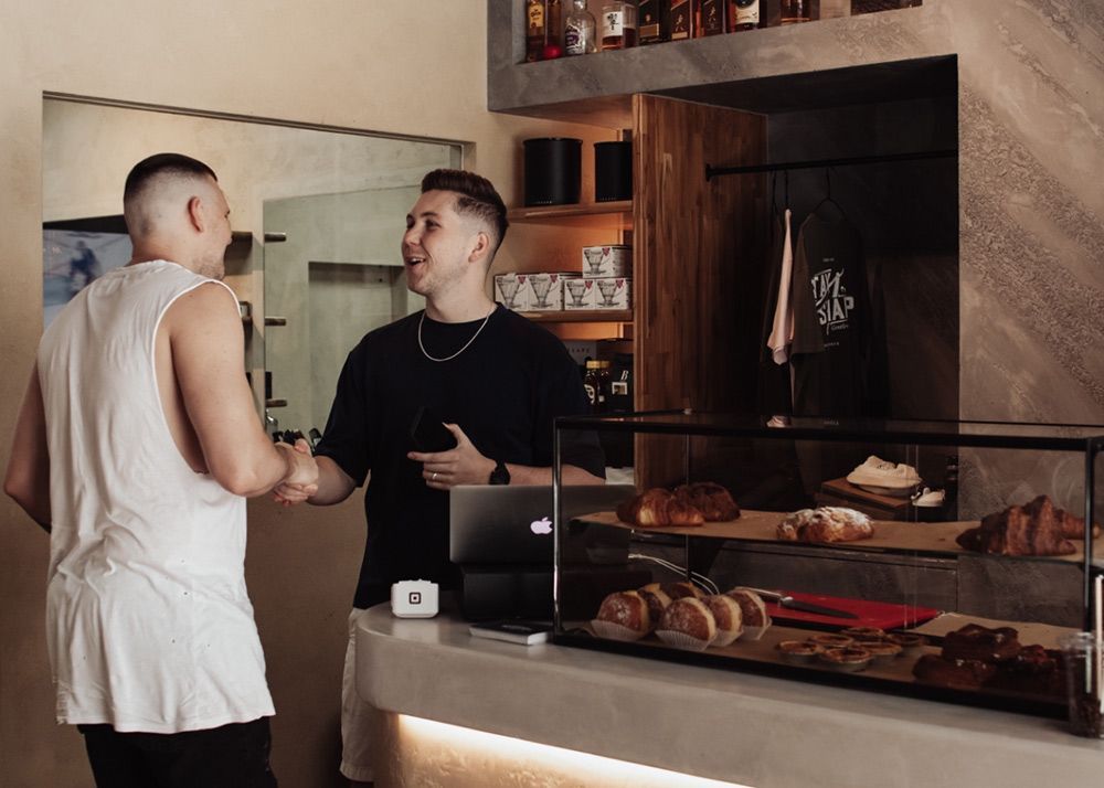 Two Men Are Talking to Each Other In Barber Shop — Barber Bros & Co - Southport in Southport, QLD