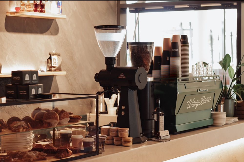 A Coffee Shop With a Grinder and Cups on the Counter — Barber Bros & Co - Southport in Southport, QLD