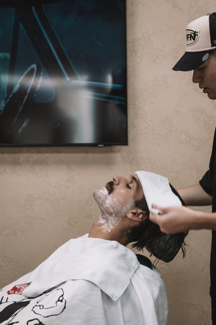 A Man is Getting a Beard Trim At Barber Shop— Barber Bros & Co - Southport in Broadbeach, QLD