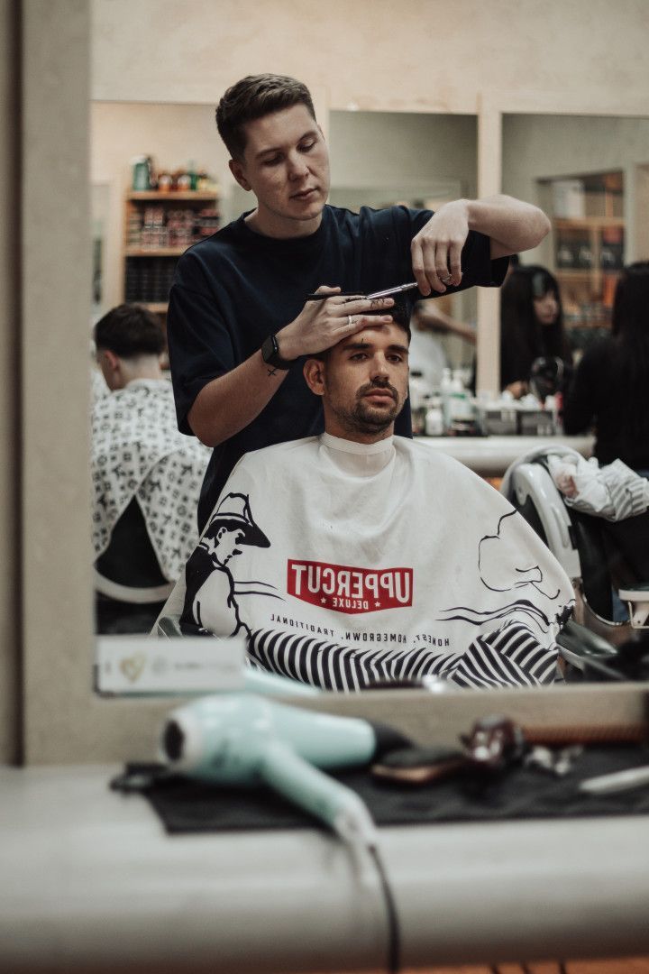 A Man Sitting Getting His Hair Cut — Barber Bros & Co - Southport in Broadbeach, QLD