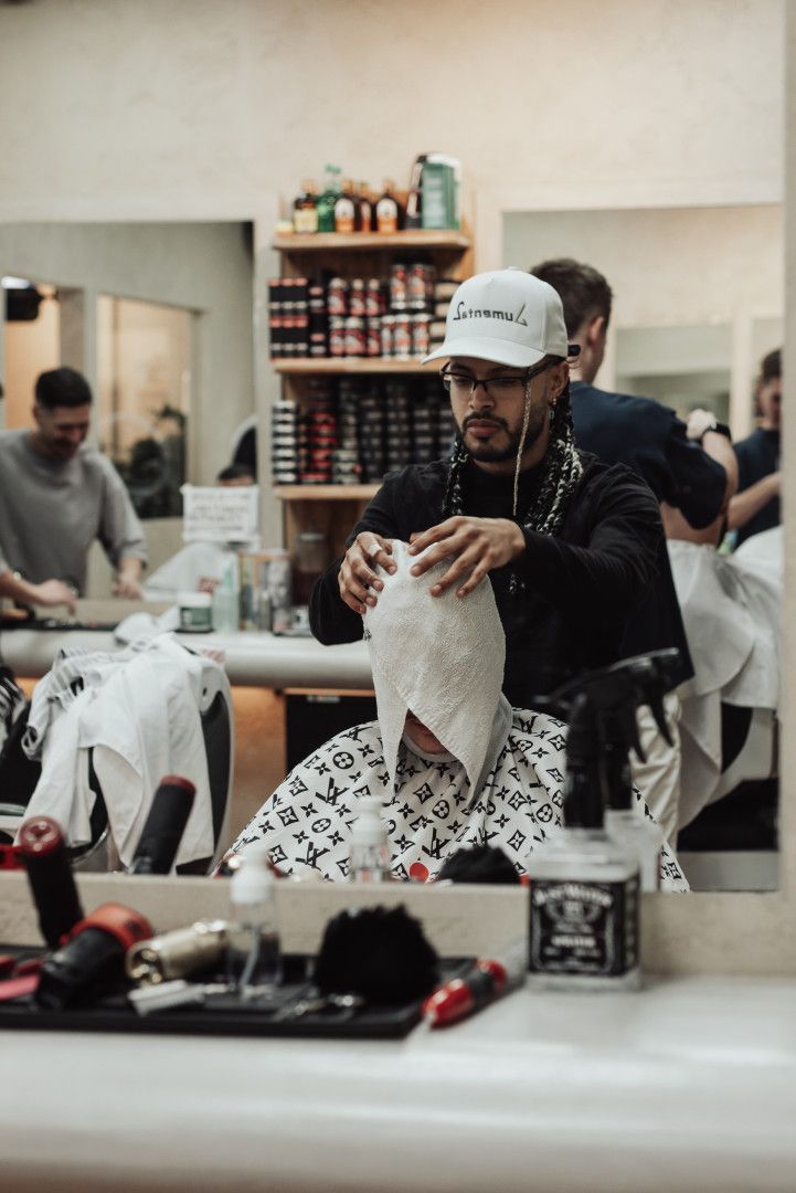 A Man is Shaving Another Man in a Barber Shop — Barber Bros & Co - Southport in Broadbeach, QLD