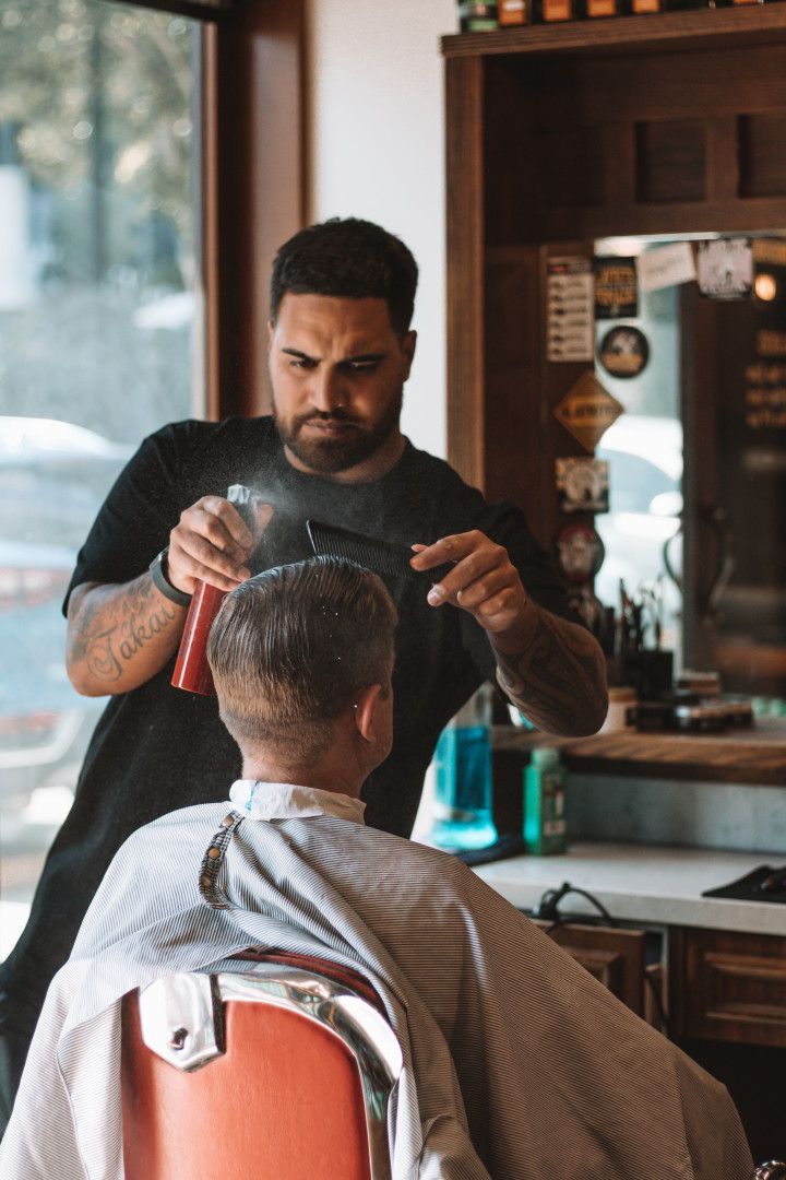Man Spraying Water on Client's Hair — Barber Bros & Co - Southport in Isle of Capri, QLD