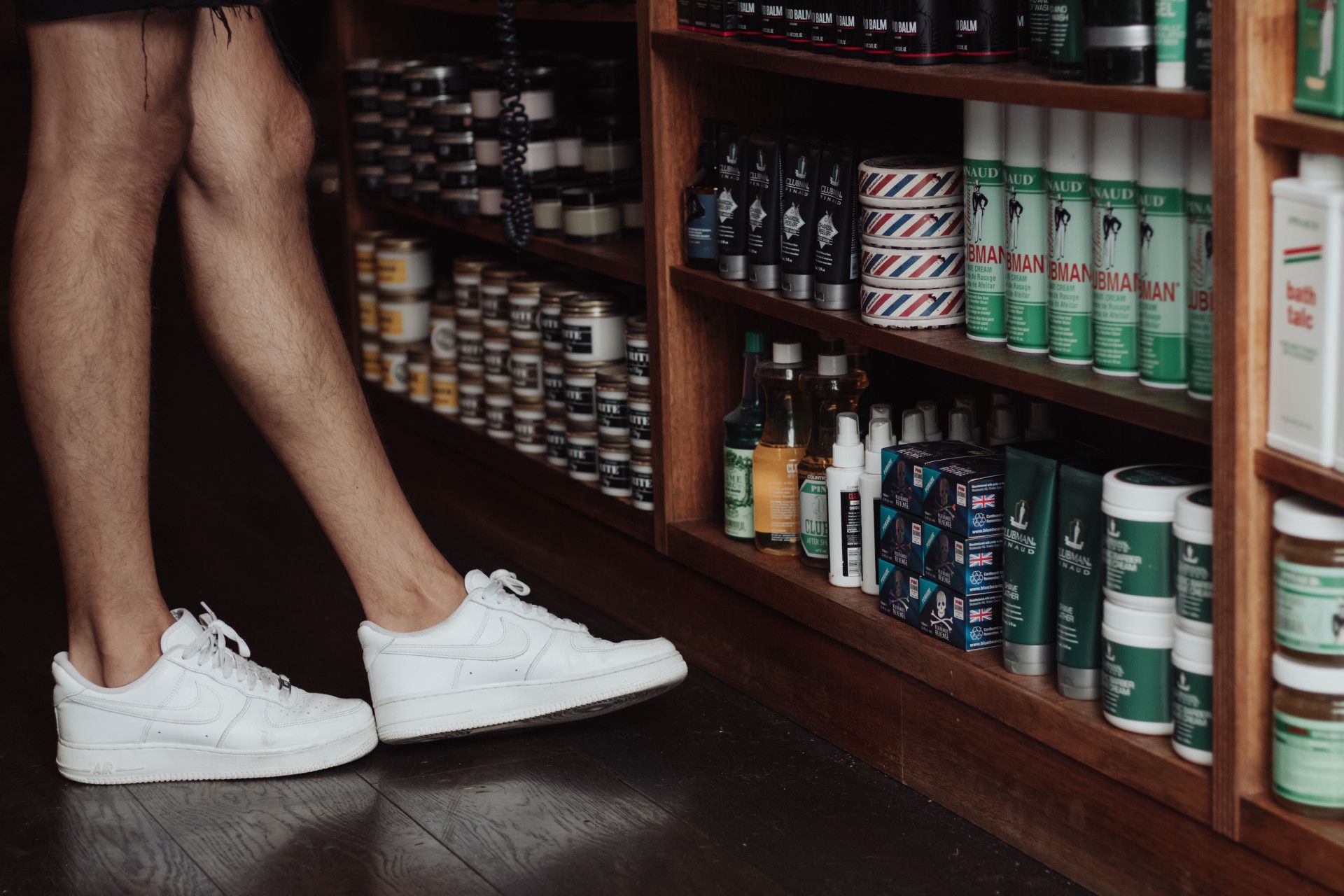 Mans Legs Next To Hair Product Shelf — Barber Bros & Co - Southport in Isle of Capri, QLD