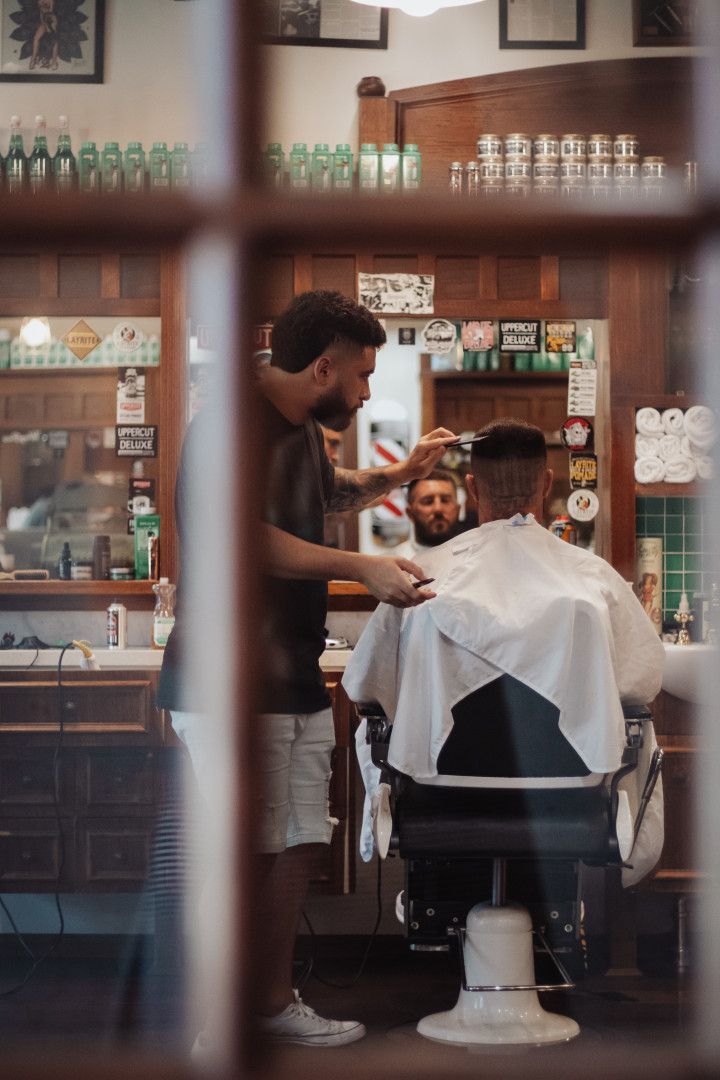 A Man is Standing Beside Man Whilst Cutting His Hair — Barber Bros & Co - Southport in Isle of Capri, QLD