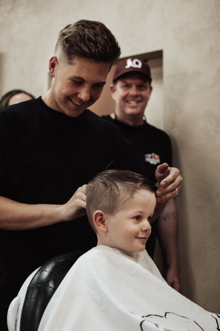 Little Boy Smiling While Getting His Hair Cut — Barber Bros & Co - Southport in Broadbeach, QLD