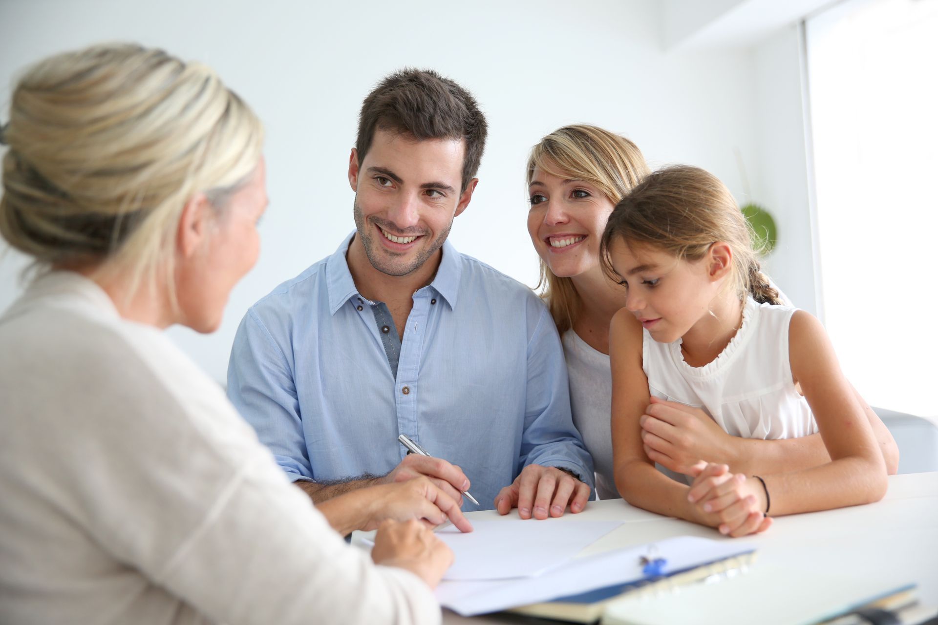 People in a counseling session talking with a therapist across a table