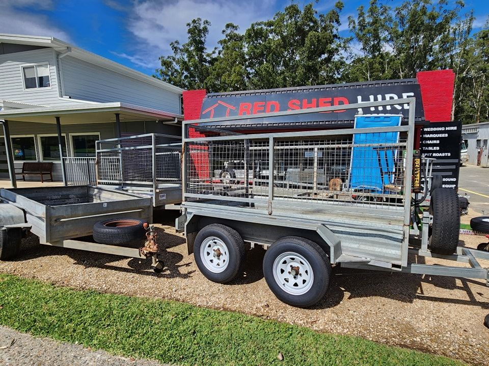 Two Trailers Parked Outside a Building — Red Shed Hire In Wauchope, NSW