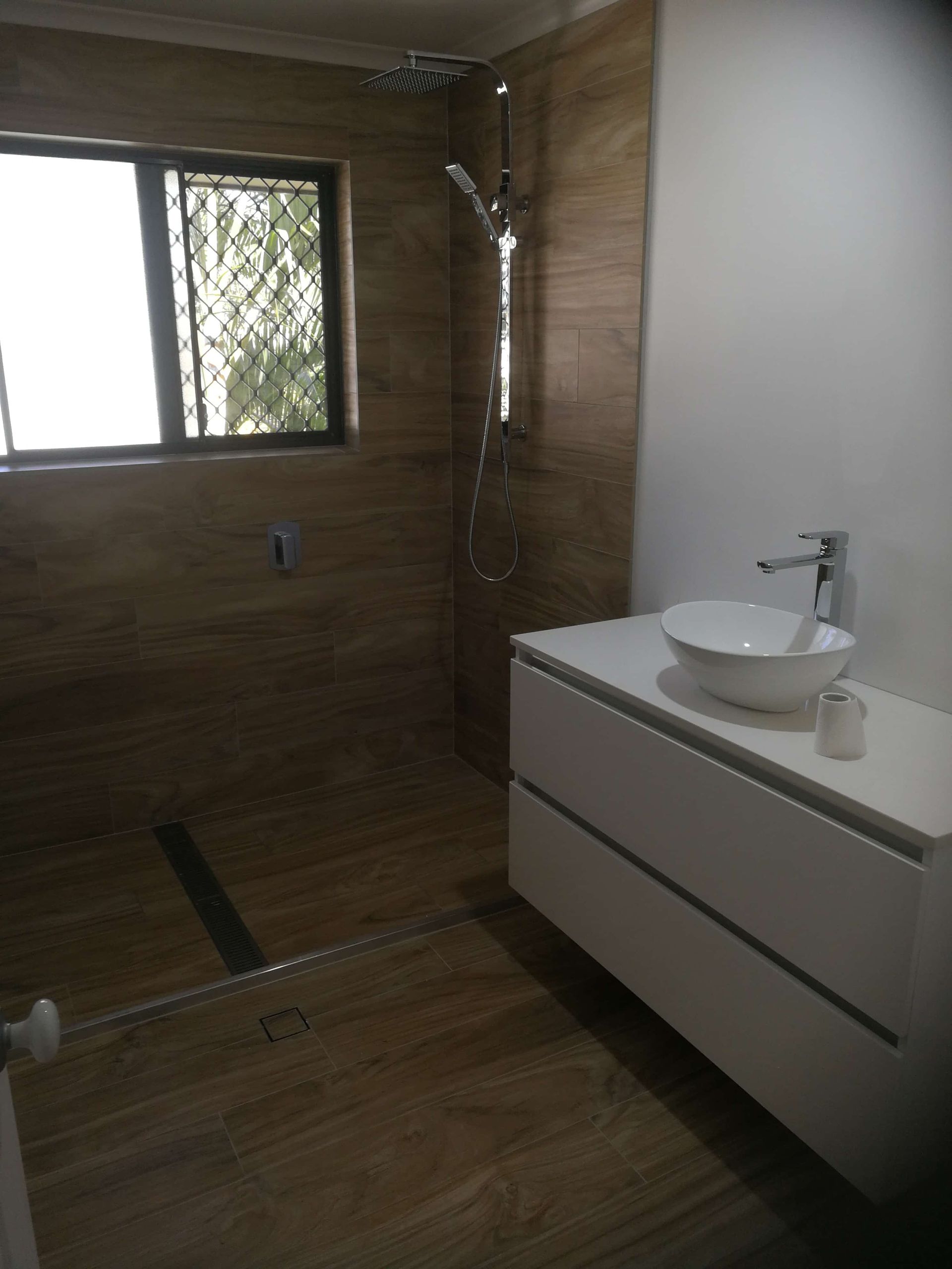 A Bathroom With a Sink and a Walk in Shower — Coastwide Plumbing Solutions in Sippy Downs, QLD