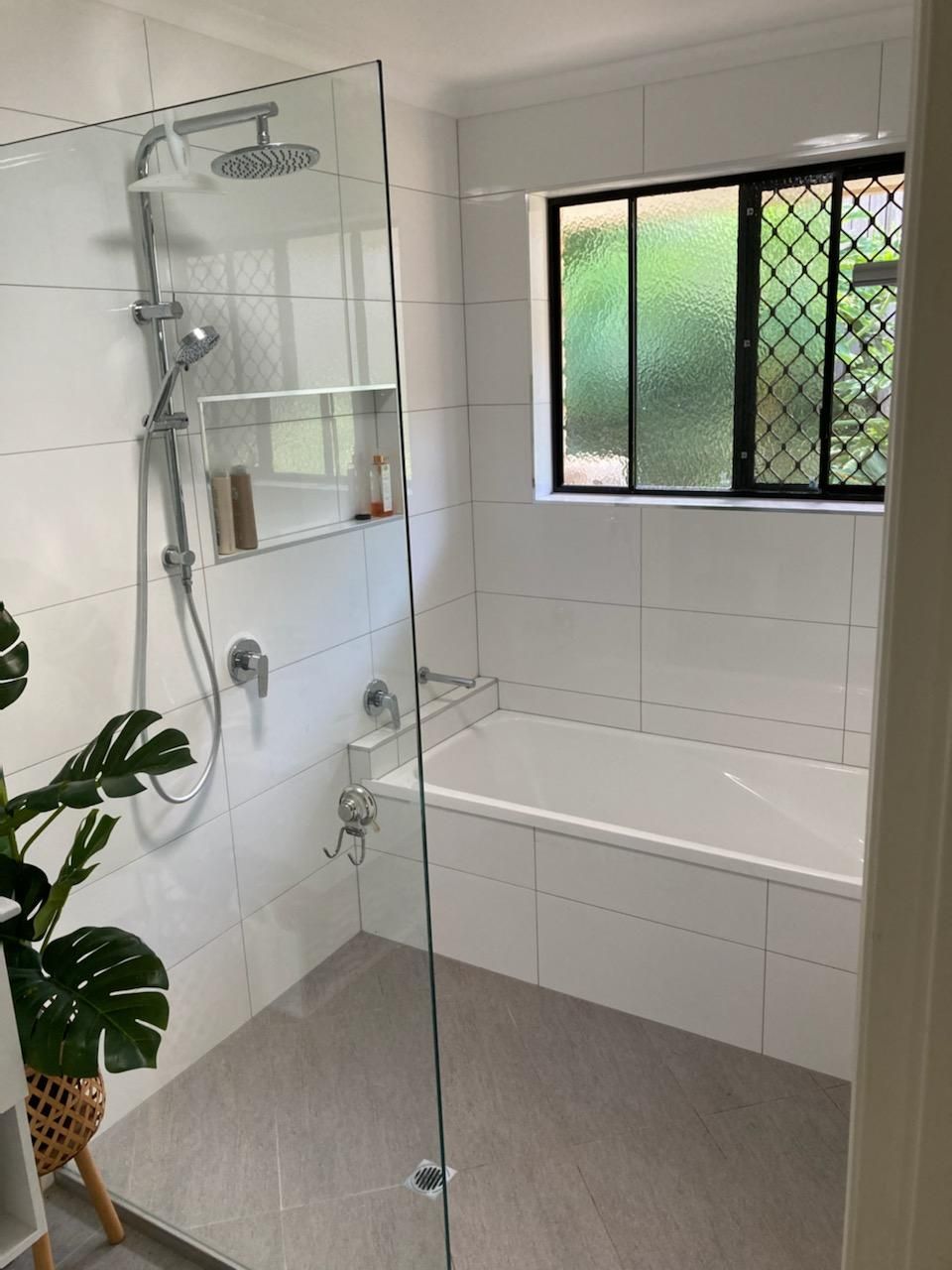 A Bathroom With a Shower, Tub and Window — Coastwide Plumbing Solutions in Sippy Downs, QLD
