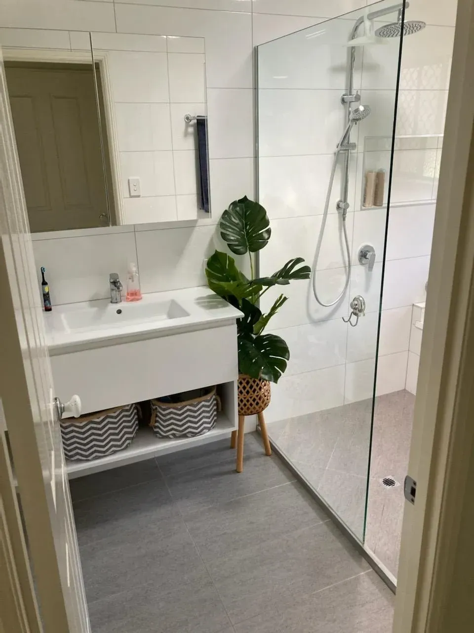 A Bathroom With a Sink, Mirror and Shower — Coastwide Plumbing Solutions in Sippy Downs, QLD