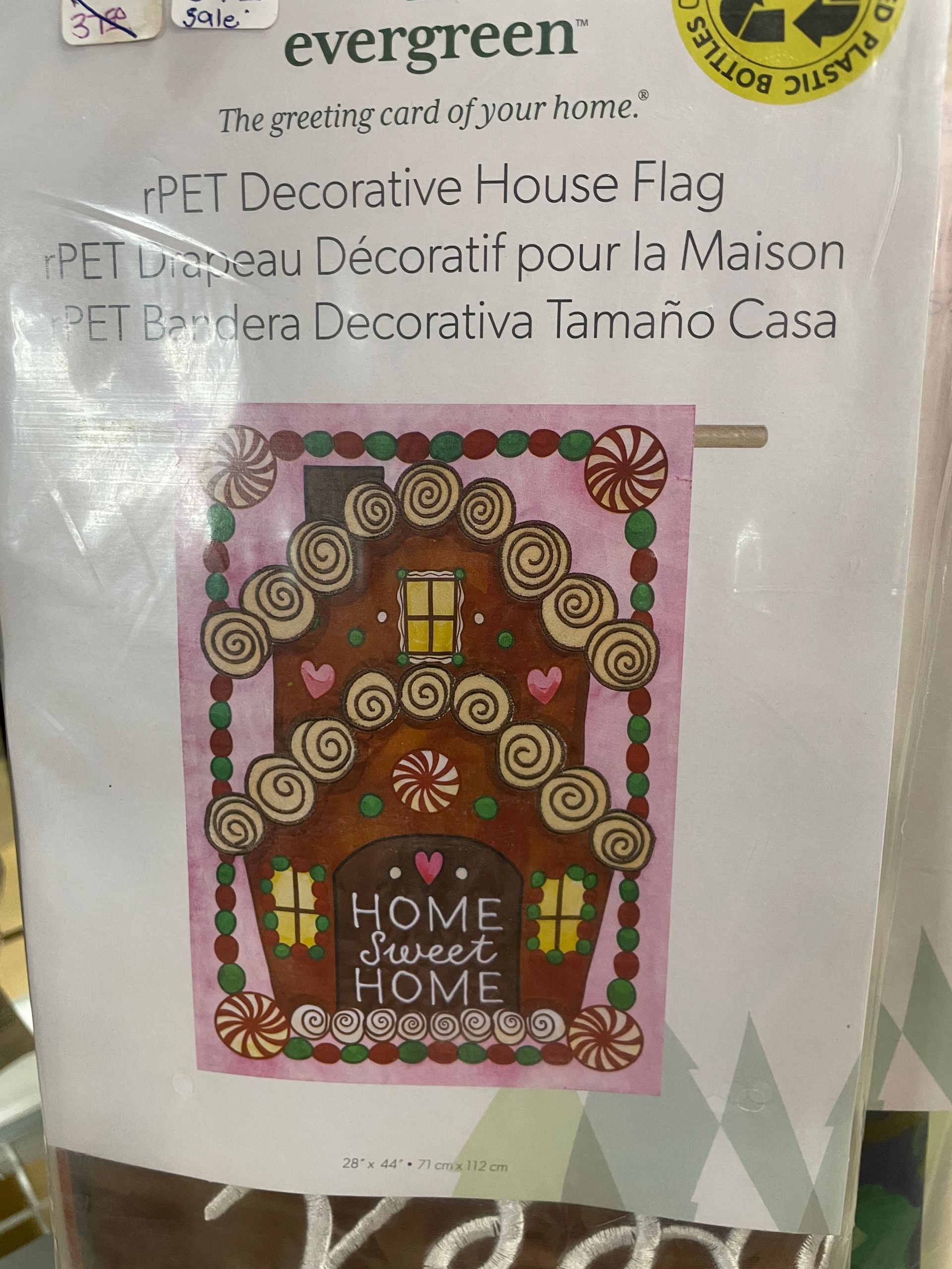 Decorative house flag featuring a gingerbread house with