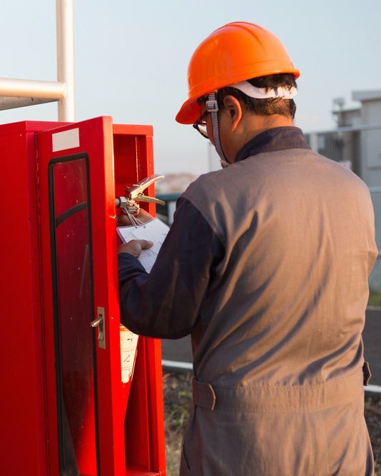 Safety Official Checking Fire Extinguisher — Fire Safety in Tamworth, NSW