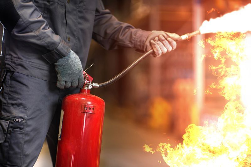 Man Using Fire Extinguisher — Fire Safety in Tamworth, NSW