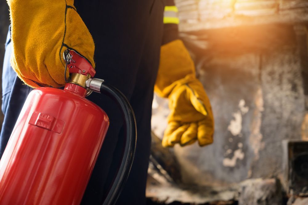 Man Carrying Fire Extinguisher — Fire Safety in Sydney, NSW