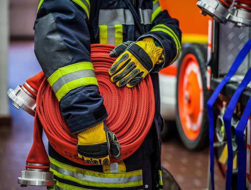 Holding Fire Hose — Fire Safety in Coffs Harbour, NSW