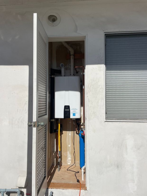 A door that is open to a room with a machine in it