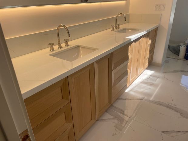 A bathroom with two sinks and a mirror.