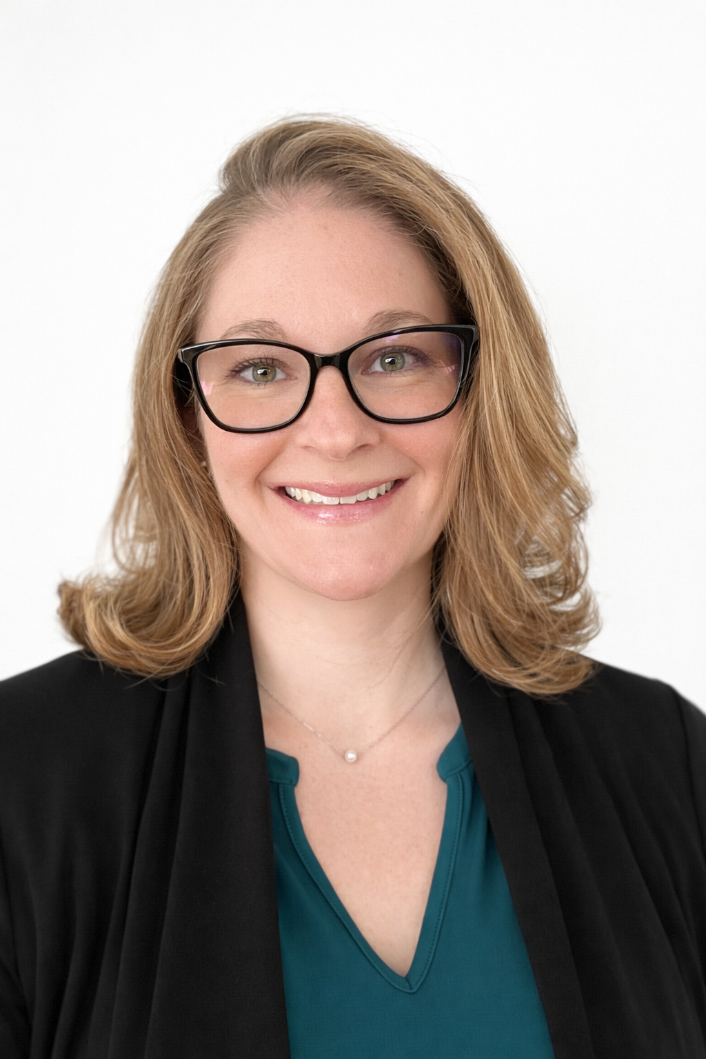 Smiling professional in glasses and black blazer against a white background
