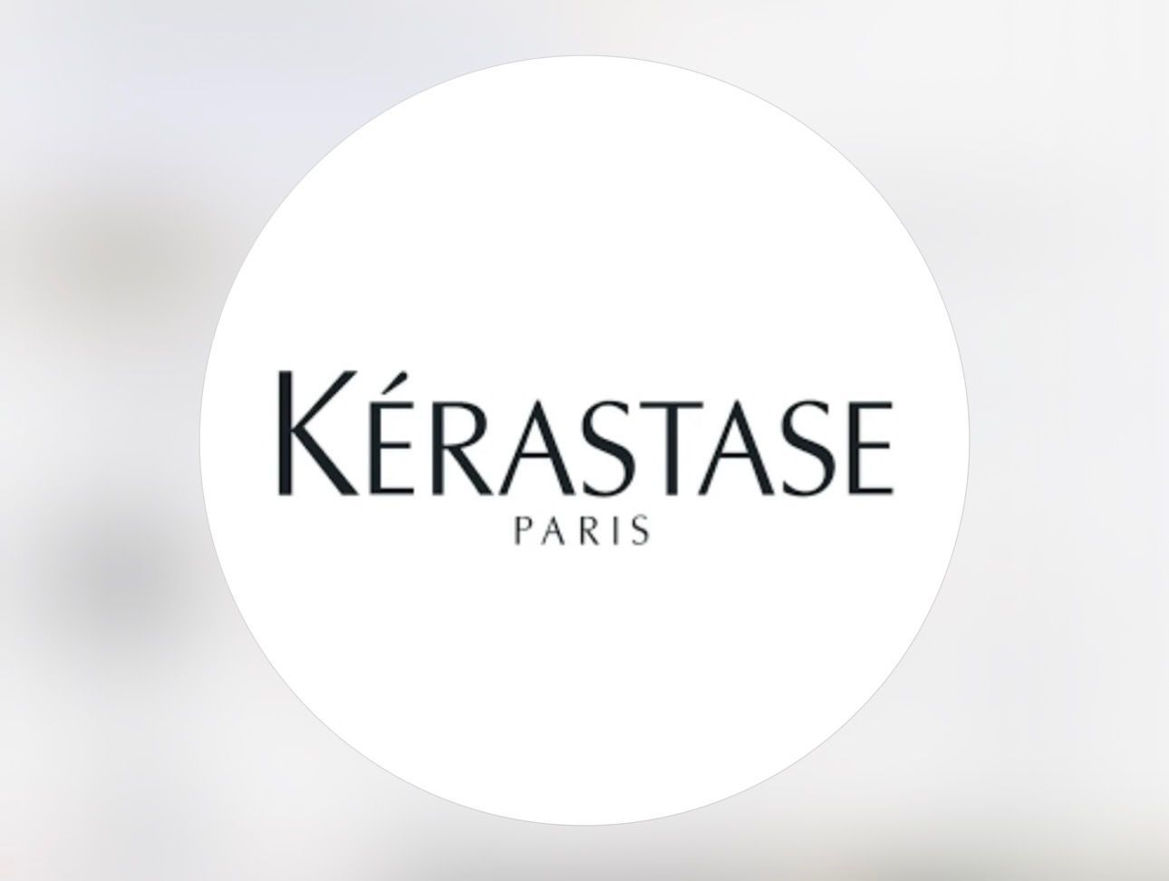 Kérastase Paris logo in black text inside a white circle on a light gray background