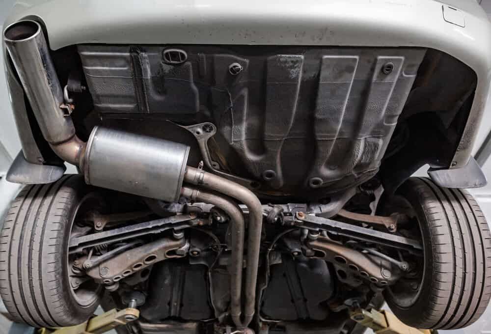 A Close Up of the Underside of a Car With a Exhaust Pipe — Shepparton Radiators & Windscreens in Cobram, VIC
