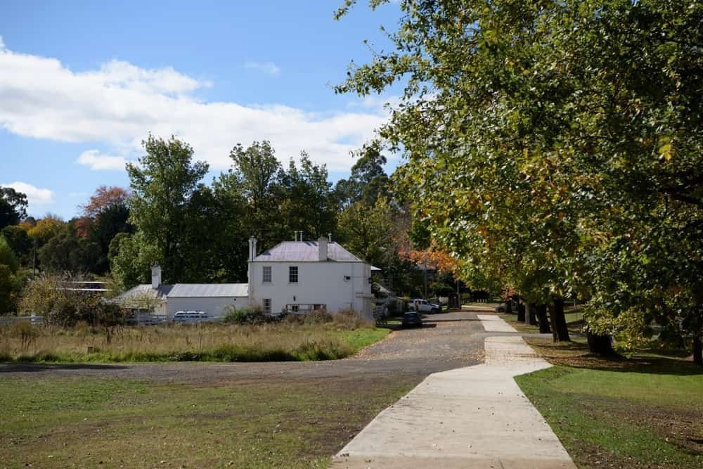 A White House With a Purple Roof is Surrounded by Trees and Grass — Shepparton Radiators & Windscreens in Cobram, VIC