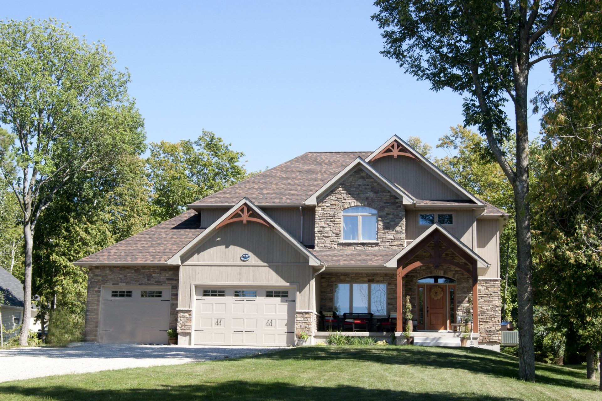 A large house with a lot of trees in the background