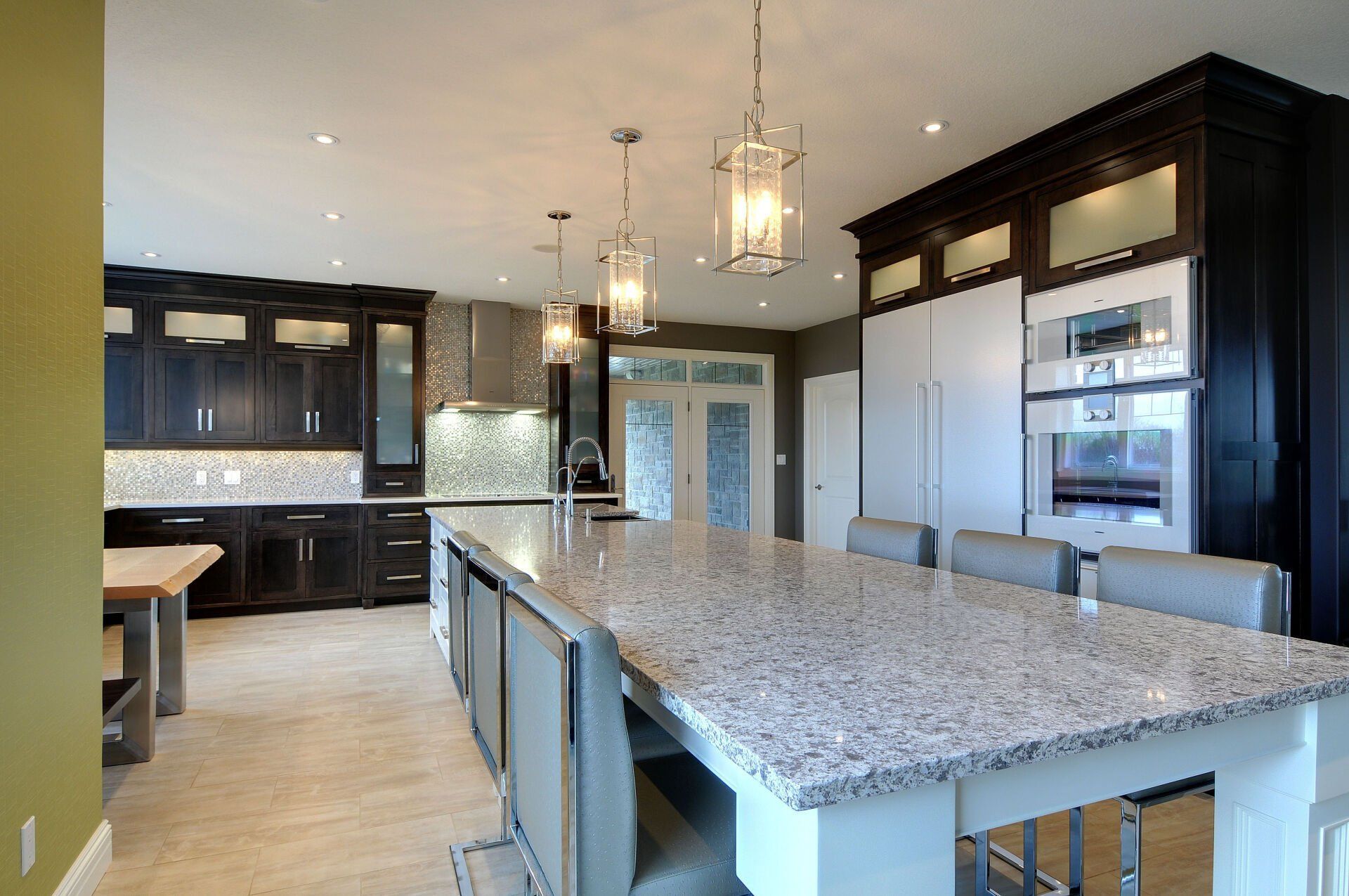 A kitchen with granite counter tops and black cabinets