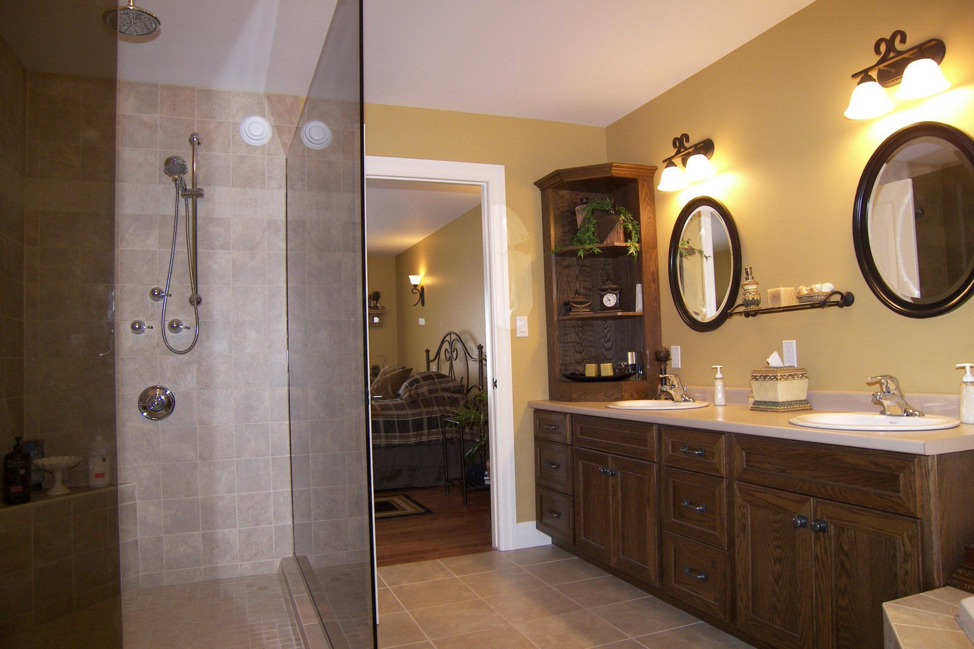 A bathroom with two sinks and a walk in shower
