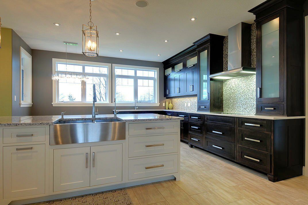 A kitchen with stainless steel appliances and white cabinets