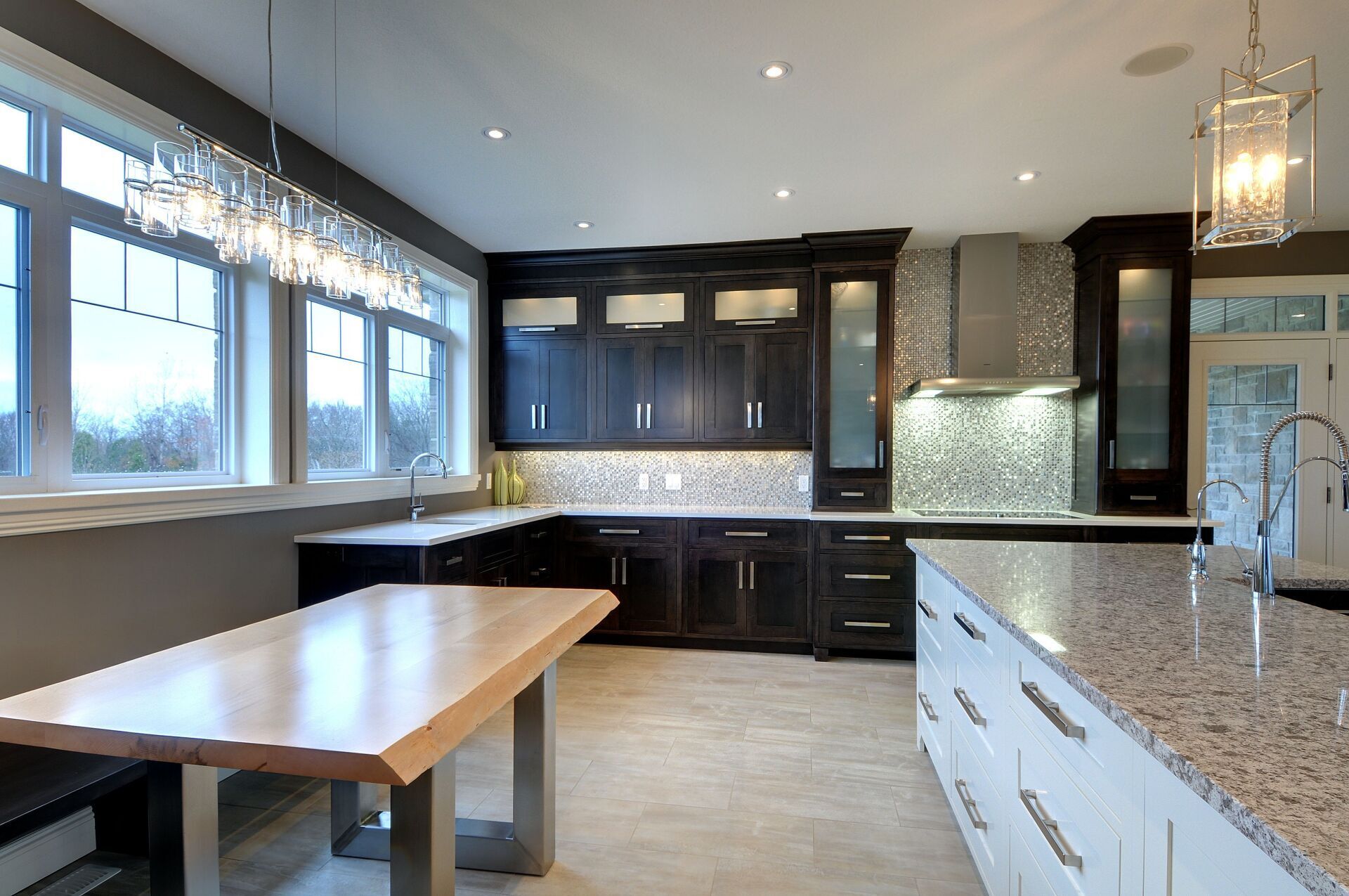 A kitchen with granite counter tops and black cabinets