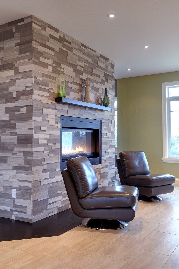 A living room with a fireplace and two chairs