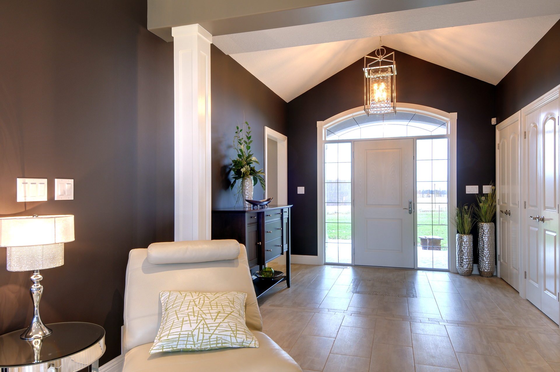 A living room with a chair and two lamps