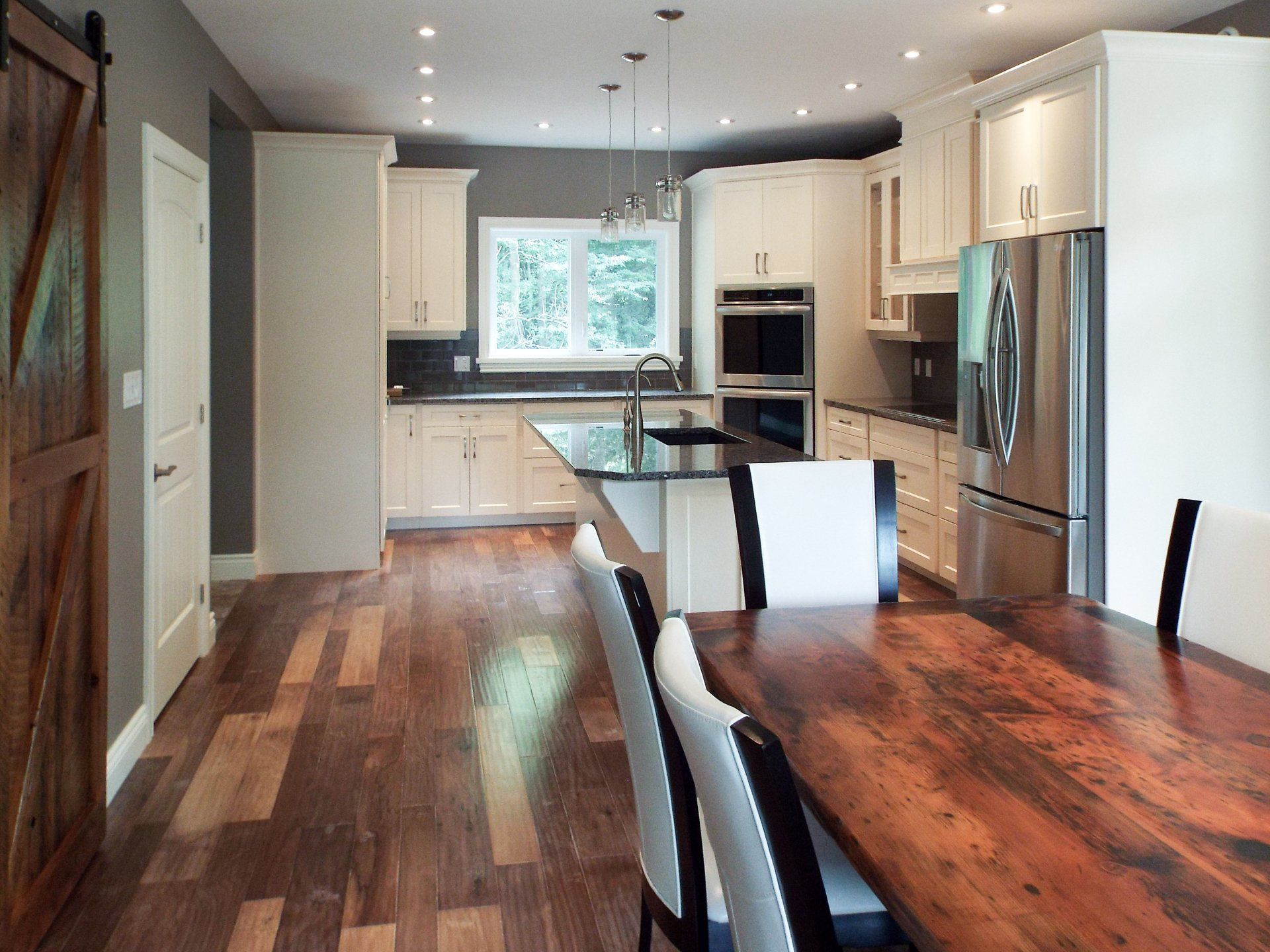A kitchen with a table and chairs in it