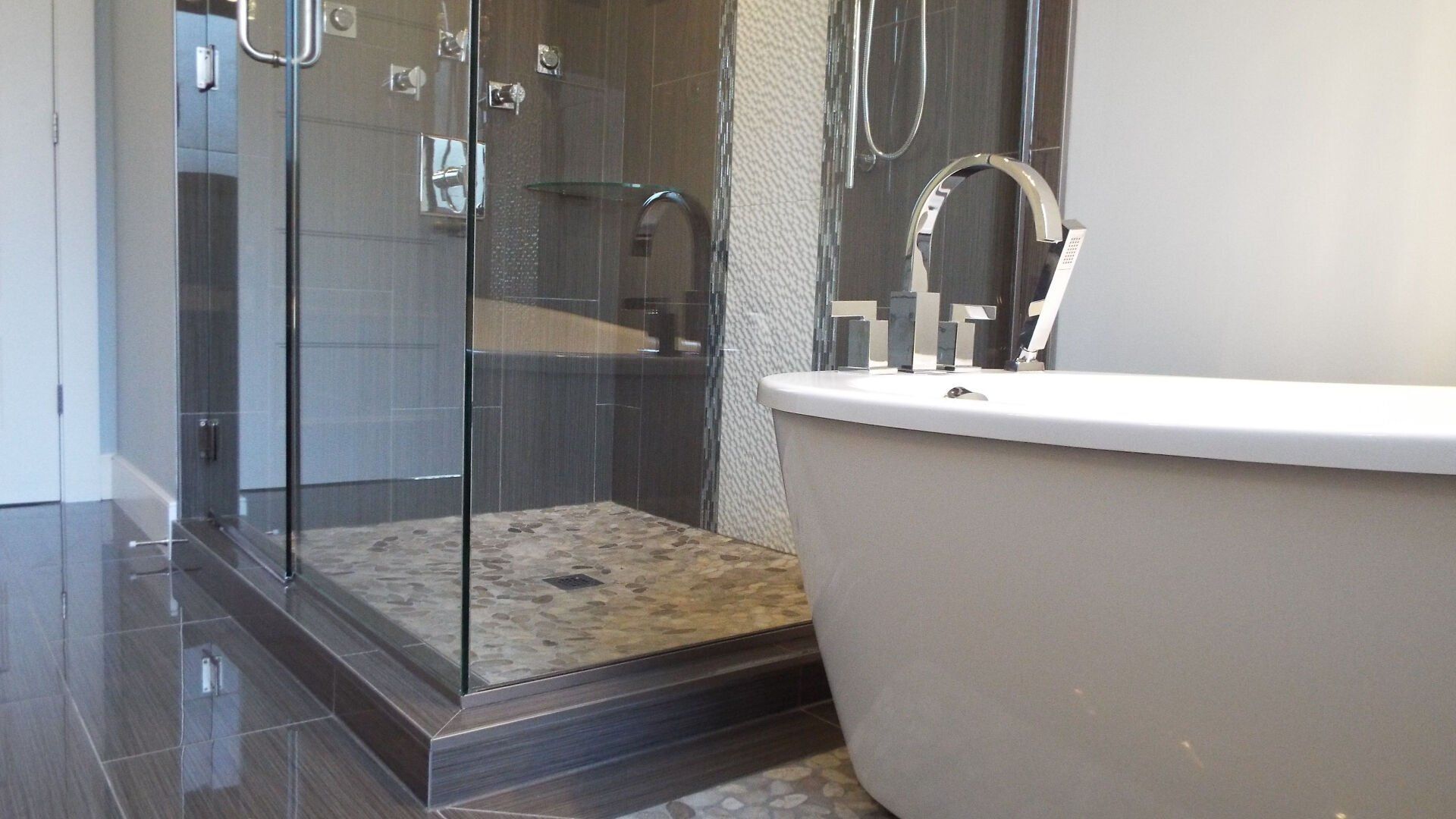 A bathroom with a bathtub and a walk in shower.